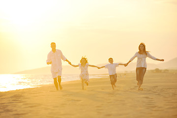 Image showing happy young family have fun on beach at sunset