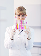 Image showing female researcher holding up a test tube in lab