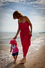 Image showing Mother with her baby  having fun on the beach