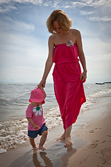 Image showing Mother with her baby  having fun on the beach