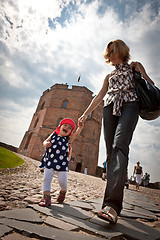 Image showing Mother and baby walking in old city