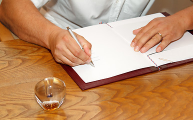 Image showing witness signing marriage license or wedding contract 