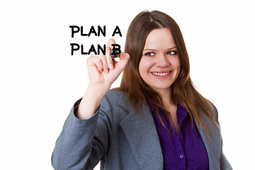 Image showing Young woman writing a plan