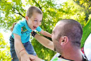 Image showing happy father and son have fun at park