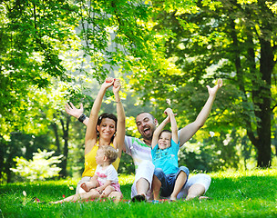 Image showing happy young couple with their children have fun at park