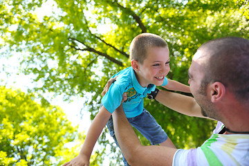 Image showing happy father and son have fun at park