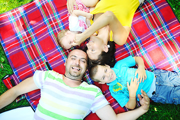 Image showing happy young couple with their children have fun at park