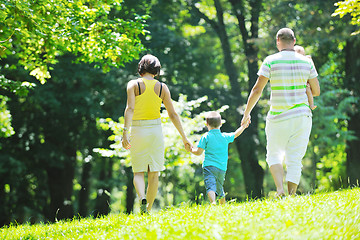 Image showing happy young couple with their children have fun at park