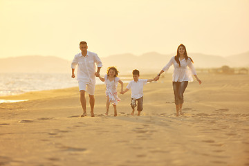 Image showing happy young family have fun on beach at sunset