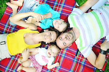 Image showing happy young couple with their children have fun at park