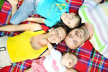 Image showing happy young couple with their children have fun at park