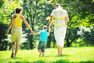 Image showing happy young couple with their children have fun at park