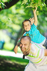 Image showing happy father and son have fun at park