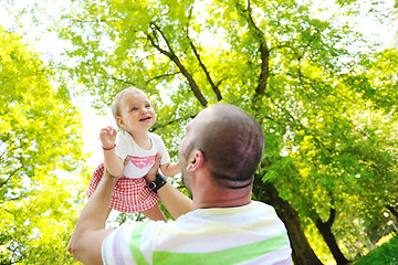 Image showing man and baby playing in park