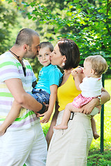 Image showing happy young couple with their children have fun at park