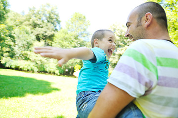 Image showing happy father and son have fun at park