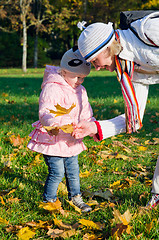 Image showing grandmother with the grand daughter in autumn park