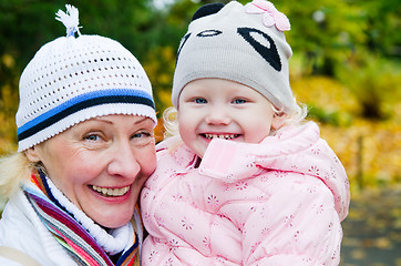 Image showing grandmother with the grand daughter in autumn park