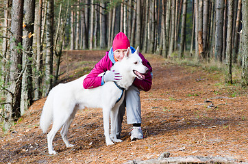 Image showing The woman with a dog in a forest park