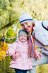 Image showing grandmother with the grand daughter in autumn park