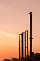 Image showing Factory chimneys at sunrise