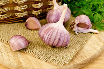 Image showing Garlic on sacking with a basket