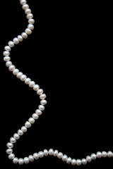 Image showing White pearls on the black silk 