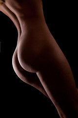 Image showing Beautiful ass of young woman over dark background
