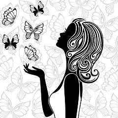Image showing Silhouette of young woman with flying butterflies