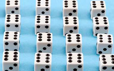 Image showing white gamble dice black dots on blue background 