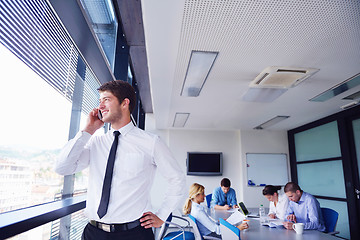 Image showing business man  on a meeting in offce with colleagues in backgroun