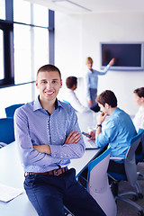 Image showing business man  on a meeting in offce with colleagues in backgroun