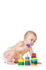 Image showing Small child play with toys on white background