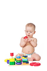 Image showing Small child play with toys on white background