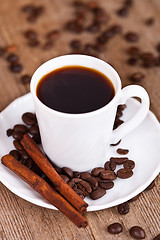 Image showing cup of coffee and cinnamon