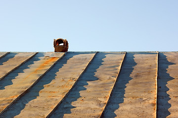 Image showing Chimney on an obsolete tinny roof