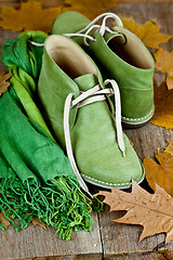 Image showing green leather boots, scarf and yellow leaves