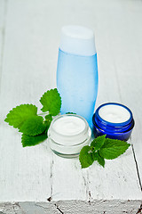 Image showing face cream and lotion with urtica leaves 