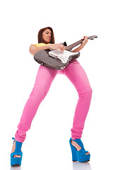 Image showing passionate young woman guitarist playing