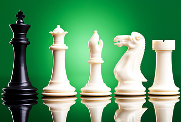 Image showing black king near white chess pieces