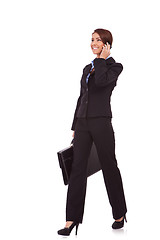 Image showing walking business woman on the phone