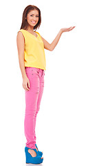 Image showing young casual woman presenting something