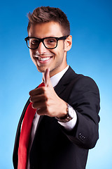 Image showing Business man shows thumbs up ok gesture