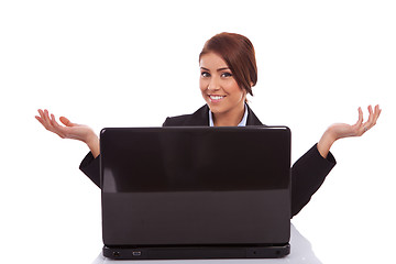 Image showing business woman is welcoming you to her desk