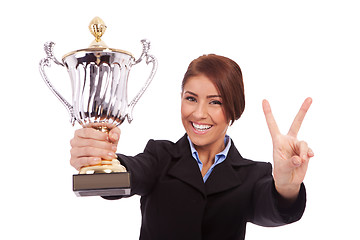 Image showing business woman with trophy make victory gesture