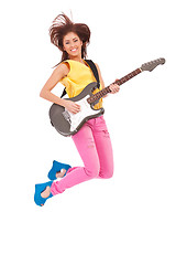 Image showing passionate woman guitarist jumps in the air