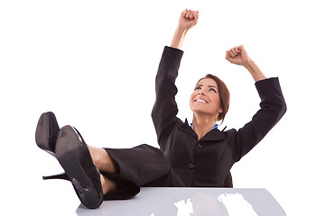 Image showing relaxed and winning business woman sitting 