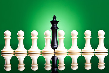 Image showing white pawns in front of a black king 