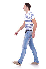 Image showing side view of a fashion man walking forward 