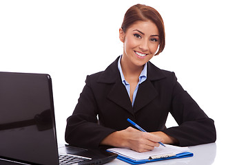 Image showing business woman at her desk writing